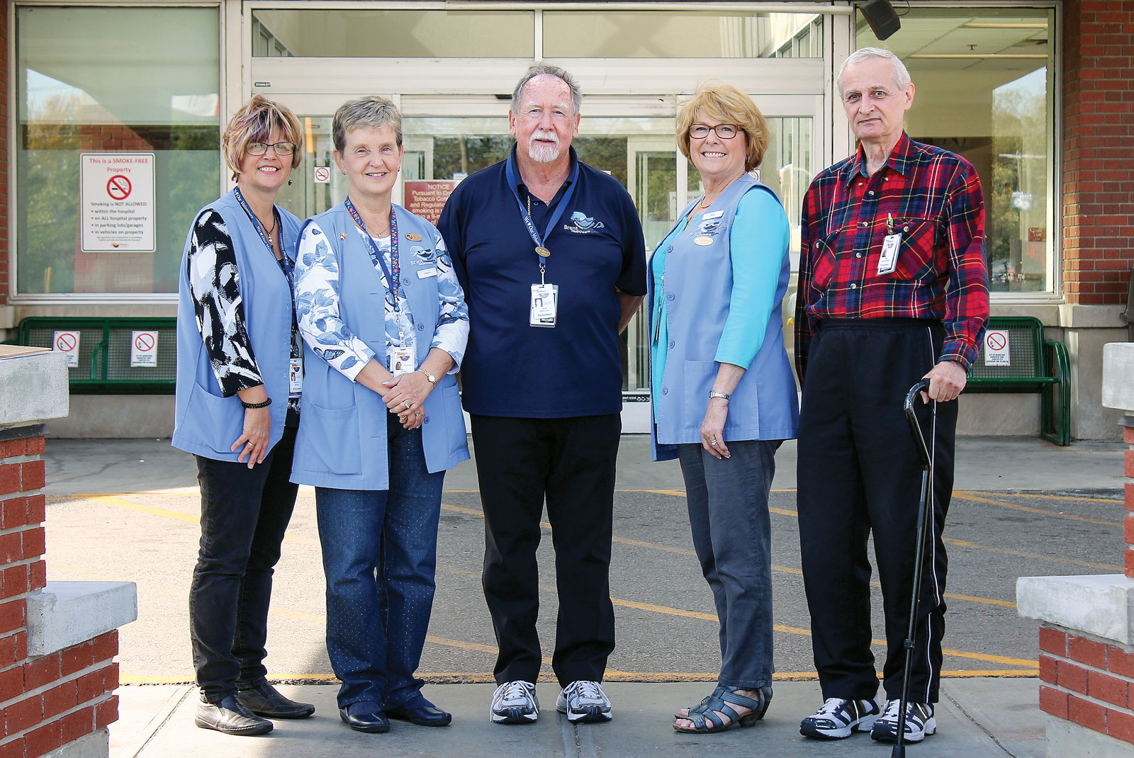 Group of voluntees outside hosital doors Group of volunteers outside hospital doors